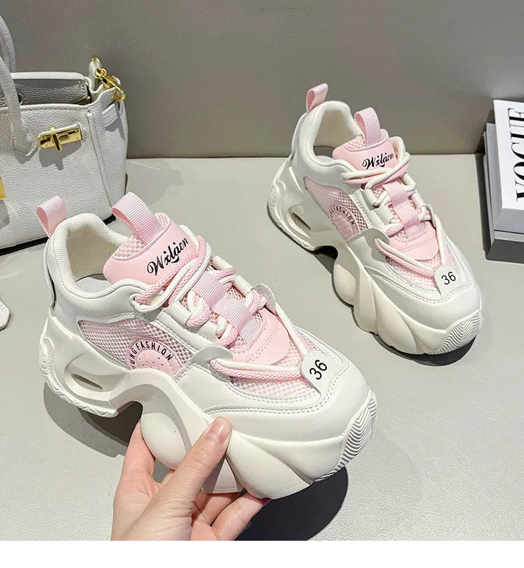 Women's beige casual sneakers with cross straps and a thick mid-height sole, shown from the side.