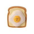 Yellow and green bread-shaped latex dog chew toy with cartoon patterns and squeaky feature