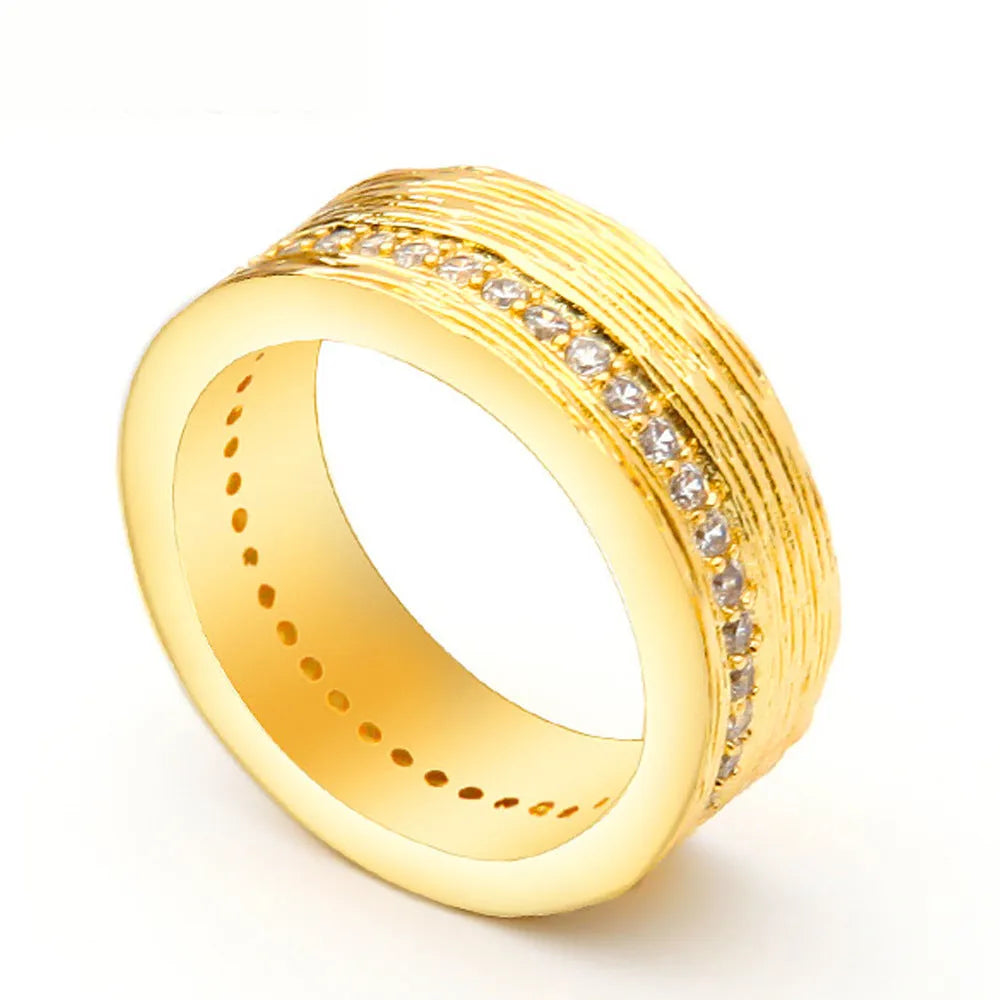 Gold geometric women's ring with clear zircon stone on copper band.