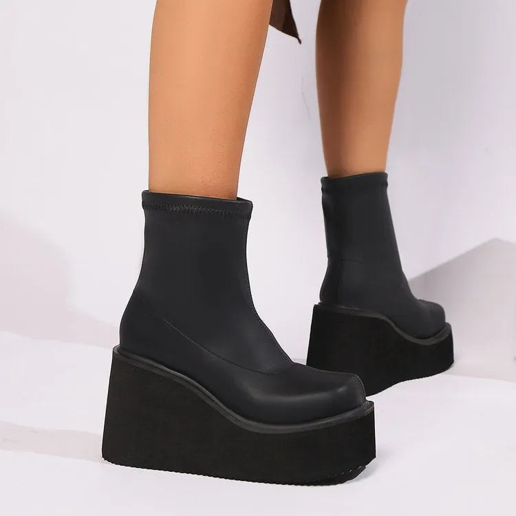 Women's black wedge heel boots with round toe, waterproof platform, and high cylinder design