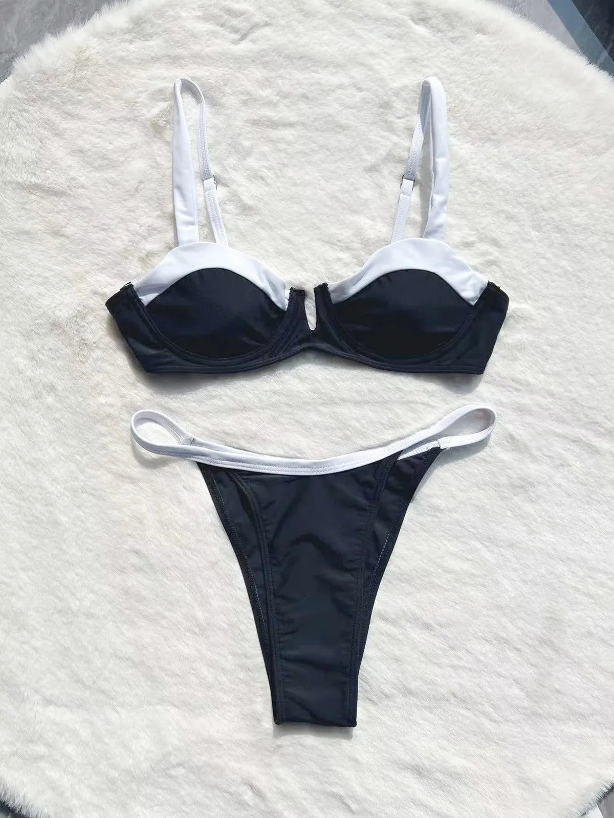 Women's black low waist bikini swimsuit with stitching detail and split leg design