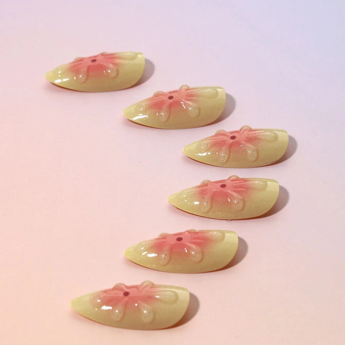 Set of plastic false nails with raised cartoon 3D flower design, jelly glue tube, and nail file.