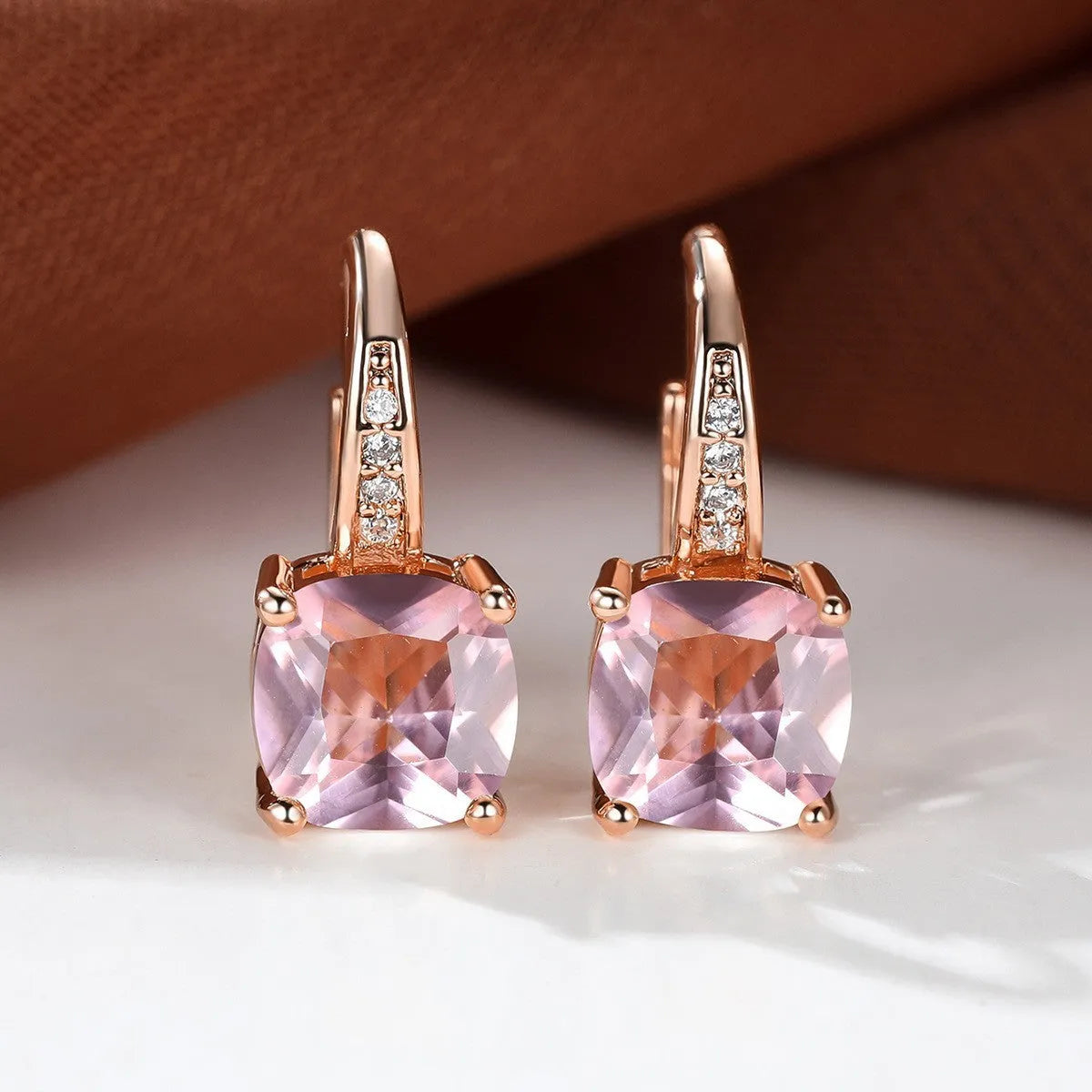 Square geometric ear hook studs with a round zircon stone, shown in a gold electroplated finish.