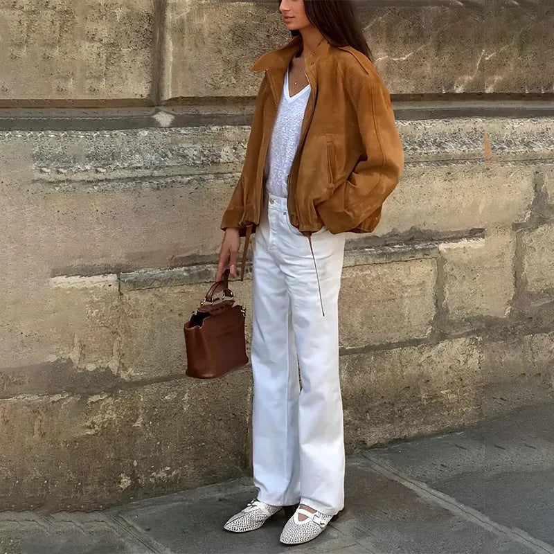 Man wearing a solid colour loose fit retro-style long sleeve polyester jacket.