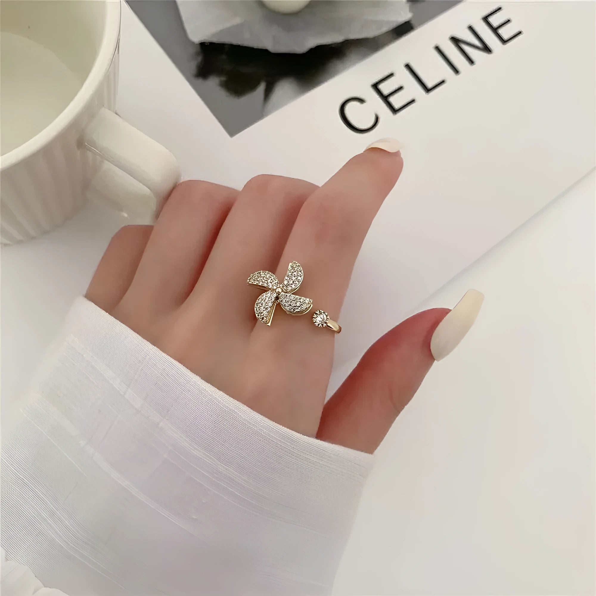 Geometric windmill rotating ring in gold electroplated finish showing circular design with movement elements