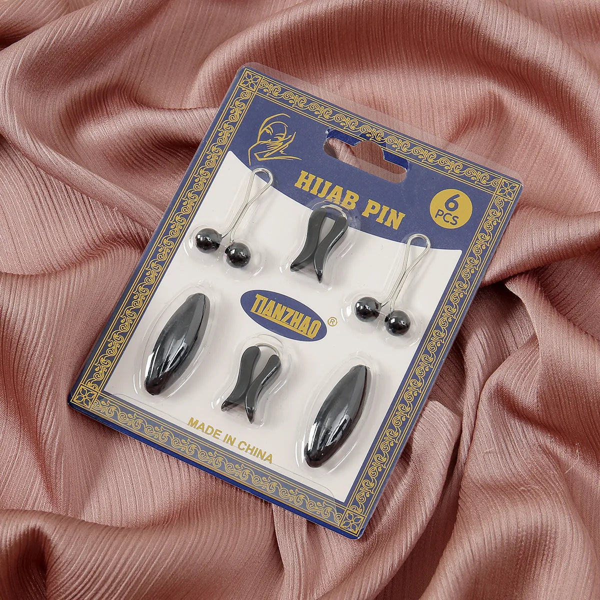 Plastic scarf clip with oval meander pattern and resin drip finish in five colours including black, gray, white, brown, and pink.