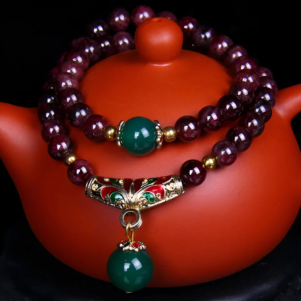 Natural garnet bracelet with 7mm beads and golden toad design on wrist