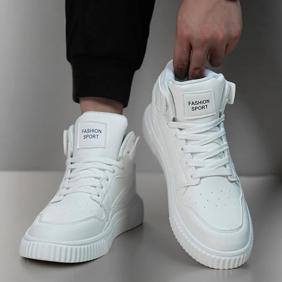 Men's white round-toe casual shoes with microfiber uppers on a plain background.