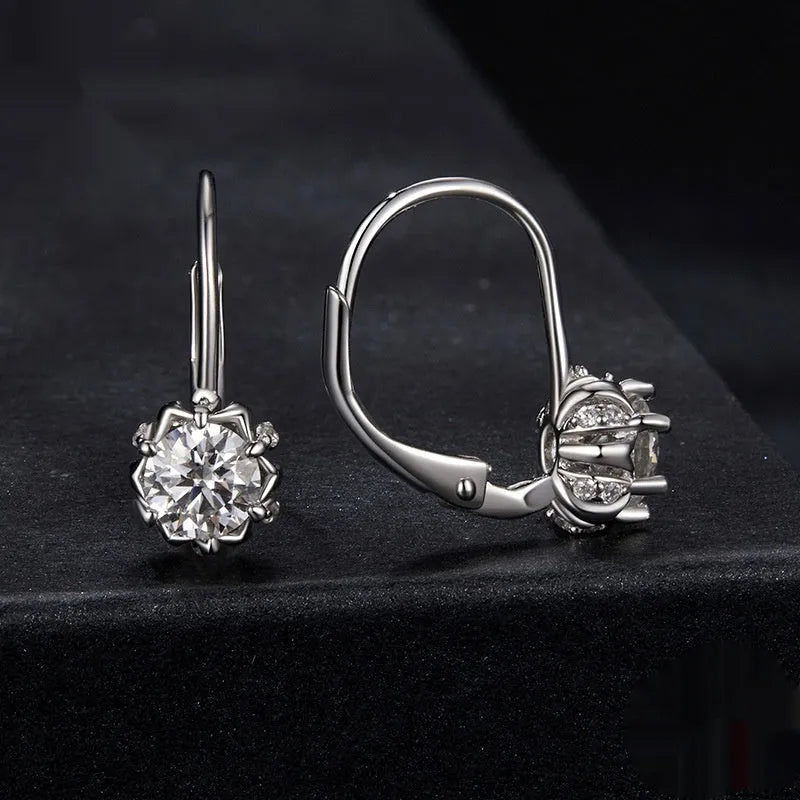 Sterling silver flower bud clip-on earrings with white gold plating and a central moissanite stone.