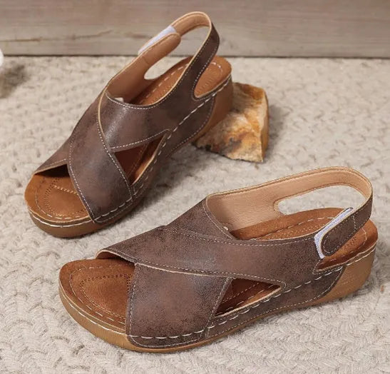 Women's brown Roman platform sandals with a skirt detail and Velcro strap.