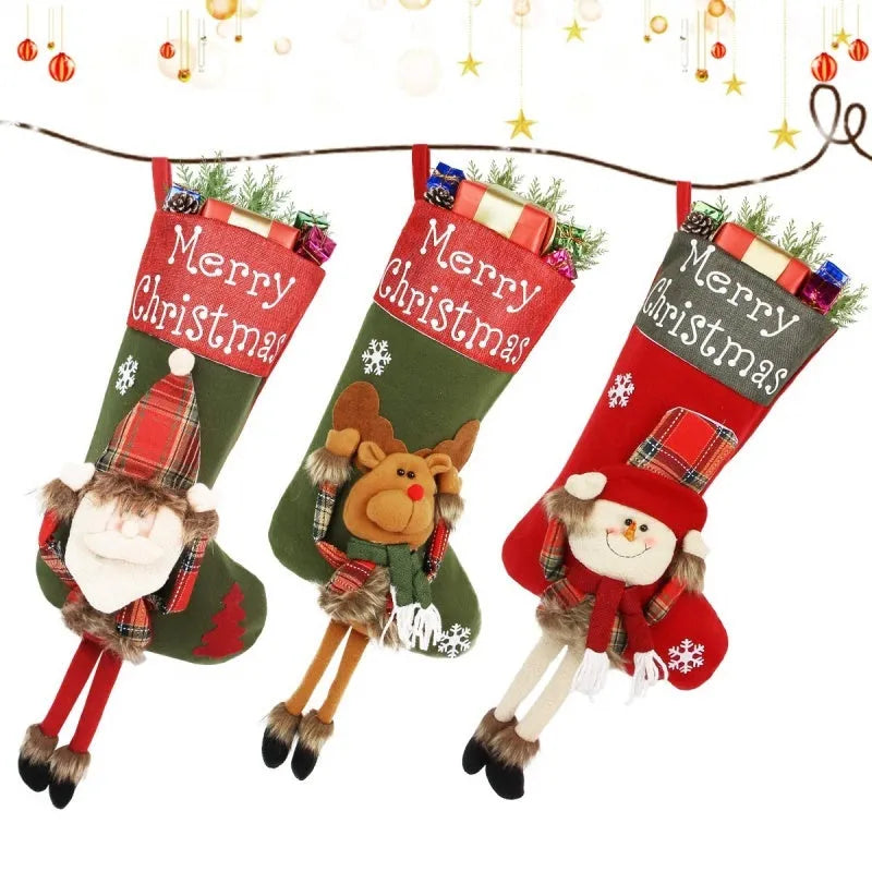 Set of three large 18-inch Christmas stockings with Santa, Snowman, and Reindeer 3D applique designs, hanging on a wooden mantel with festive decorations.