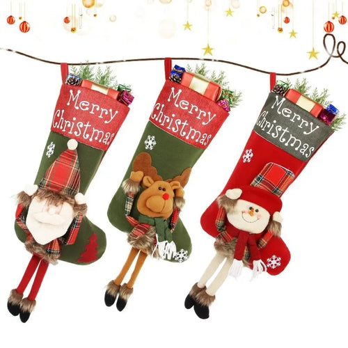 Set of three large 18-inch Christmas stockings with Santa, Snowman, and Reindeer 3D applique designs, hanging on a wooden mantel with festive decorations.