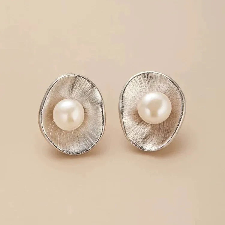 Sterling silver earrings with geometric design and cultured pearl accents on needle back fittings