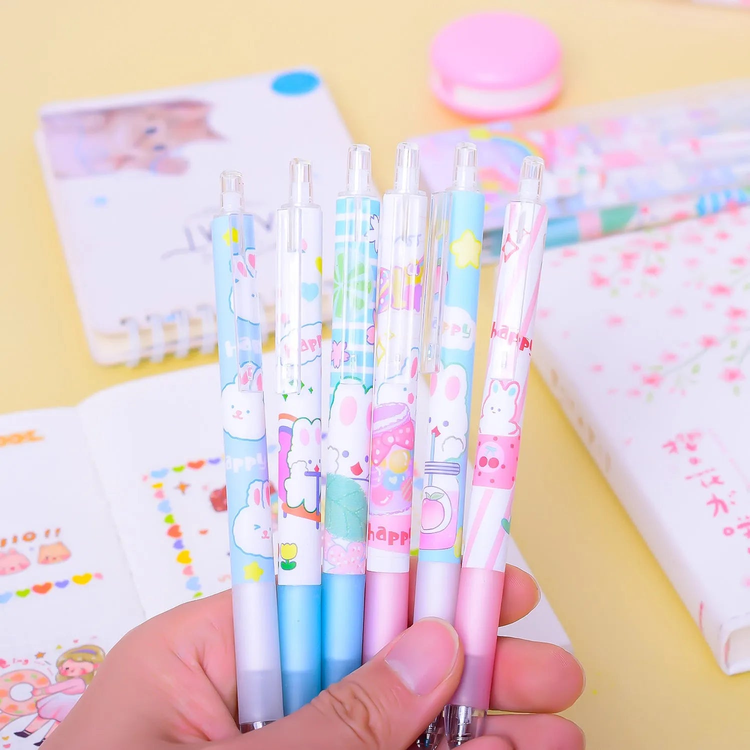 Six black gel pens with cartoon bunny designs, showing 0.5mm tips, arranged in a set.