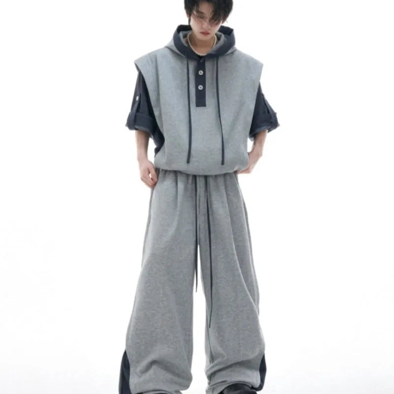Men's black heavy industry style hooded jacket with three-dimensional stitching and matching grey joggers.