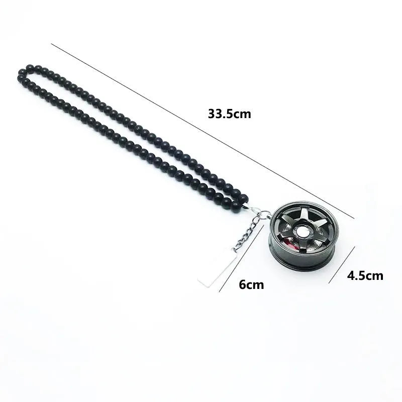 Stainless steel car tyre ornament with crystal glass bead chain hanging from a rearview mirror