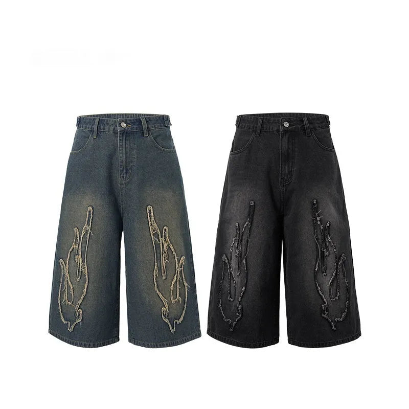 Men's black denim shorts with flame embroidery and patch detailing in straight cut design