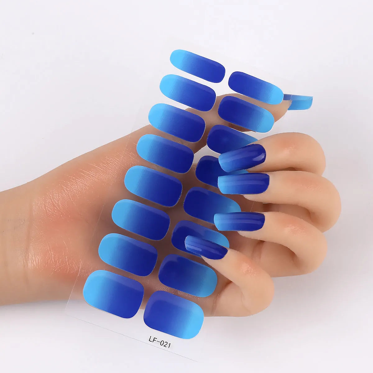 Set of 16 solid colour full nail art stickers showing patterns like cross, rose, tulip, and cartoon designs.