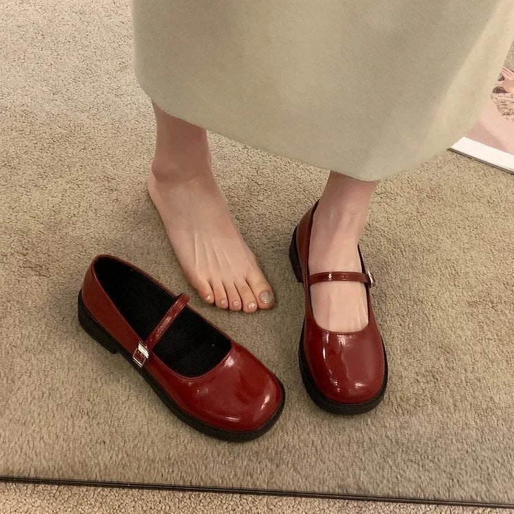 Women's solid colour flat shoes with round toe in red, black, and grey options