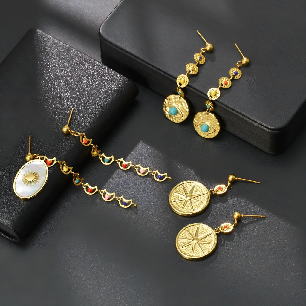 Geometric stainless steel earrings available in Eight Awn Star, Eye, and Shell Sun designs.