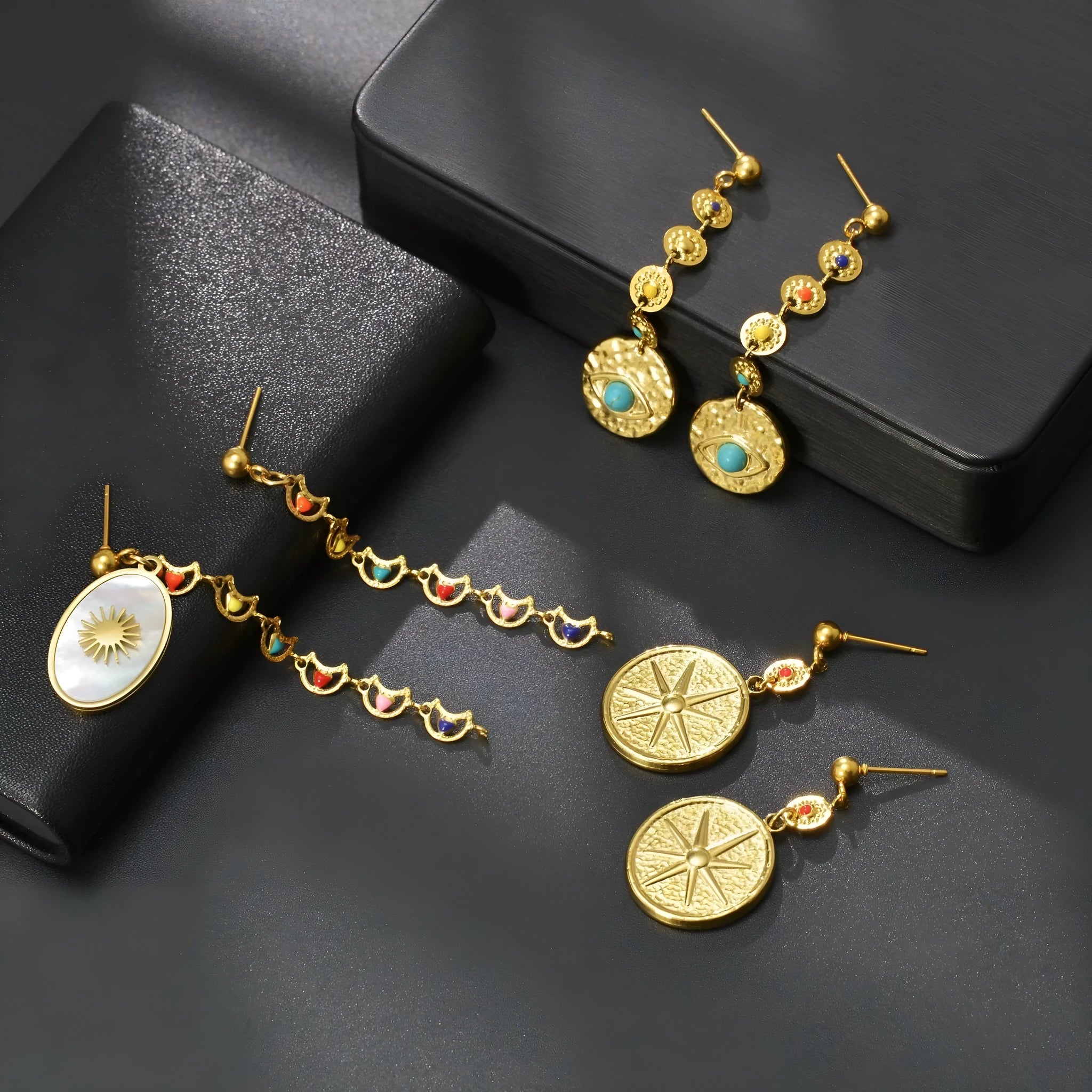 Geometric stainless steel earrings available in Eight Awn Star, Eye, and Shell Sun designs.