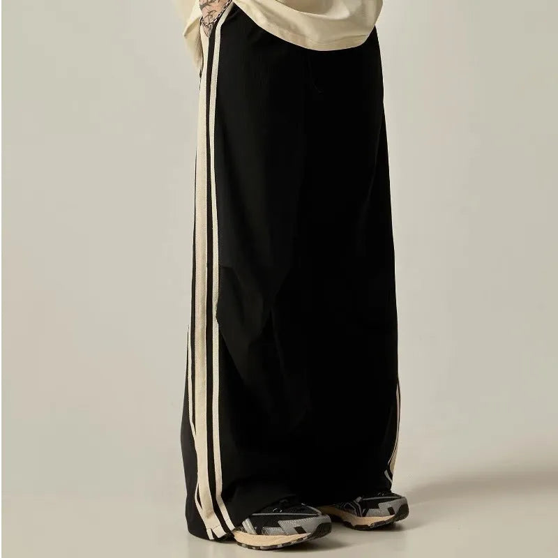Man wearing black high-waisted straight-leg casual climbing trousers.