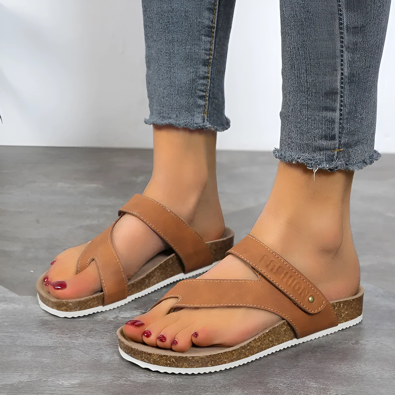 Flat toe ring thick-soled flip-flop in a solid colour on a plain background