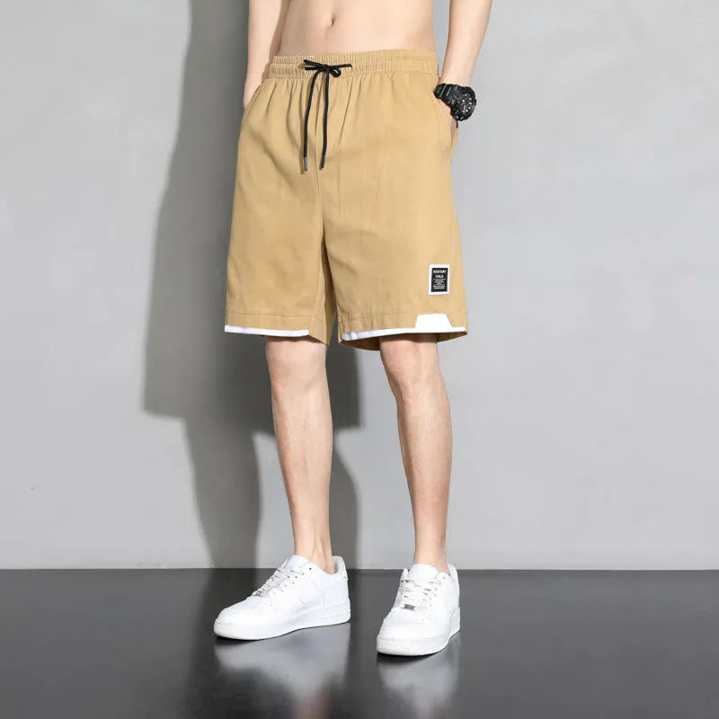 Boys cotton shorts in black, shown in a casual setting for summer.