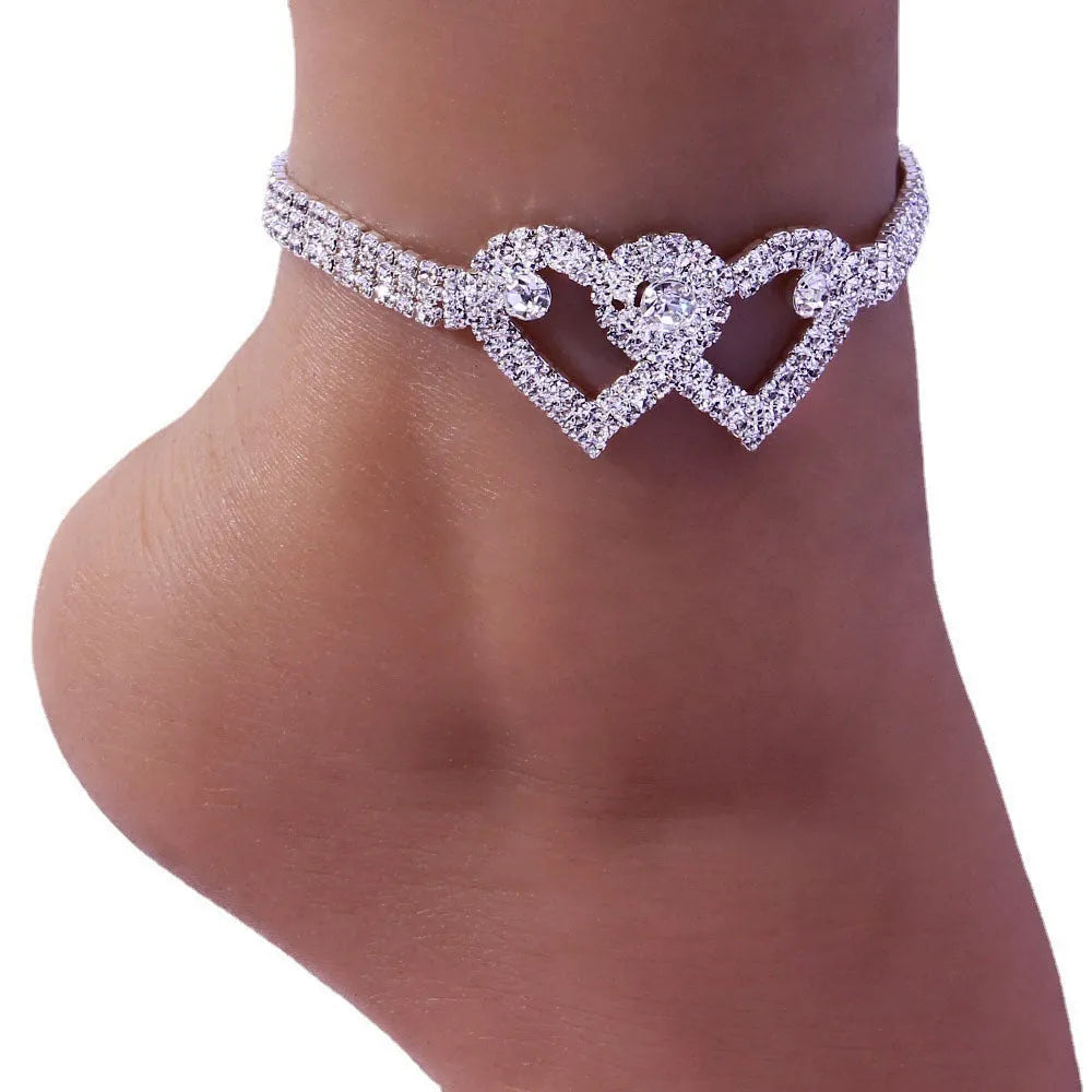 Set of two alloy double heart anklets with electroplated finish, unisex style, displayed together