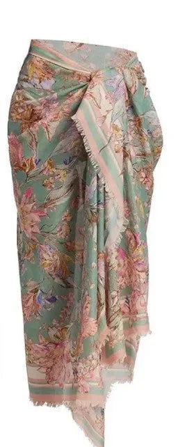 Creamy-white floral women's bikini set with matching skirt on beach