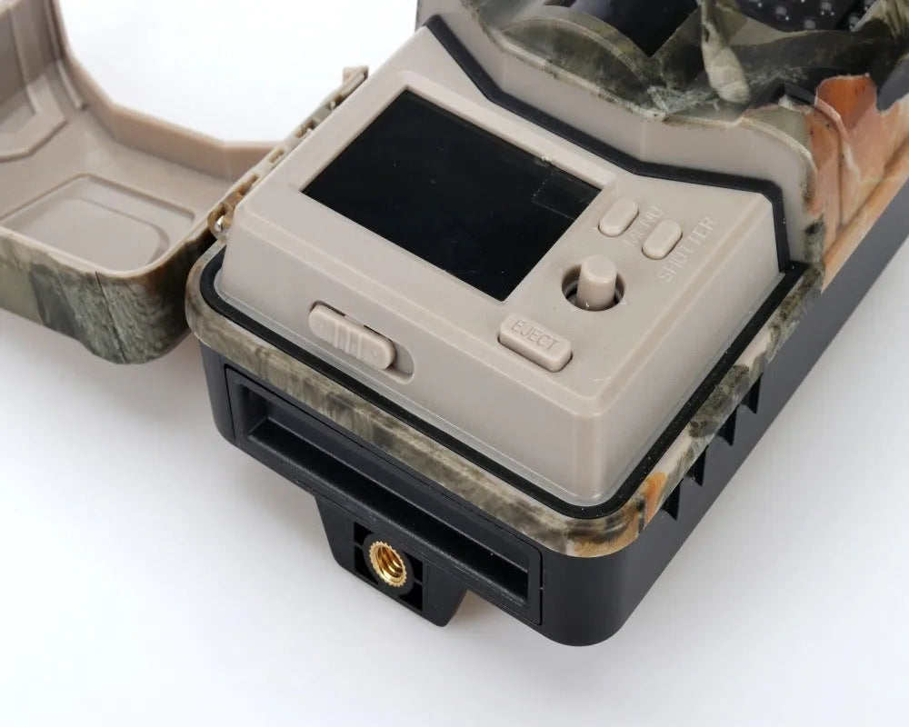 Camouflage outdoor trail camera with infrared LEDs, showing compact design for wildlife and security monitoring.