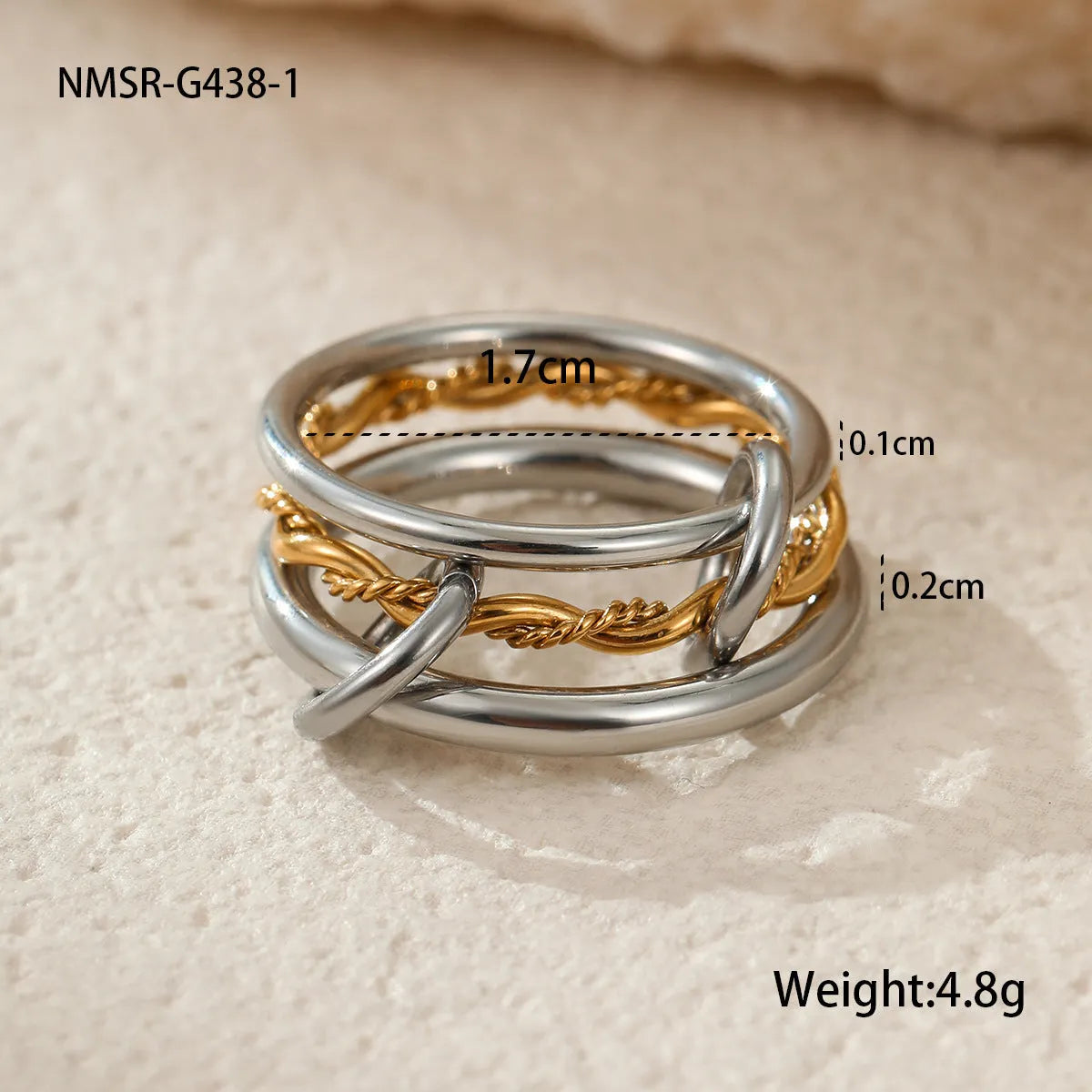 Stacked gold plated stainless steel rings showing layered jewellery look on female hand