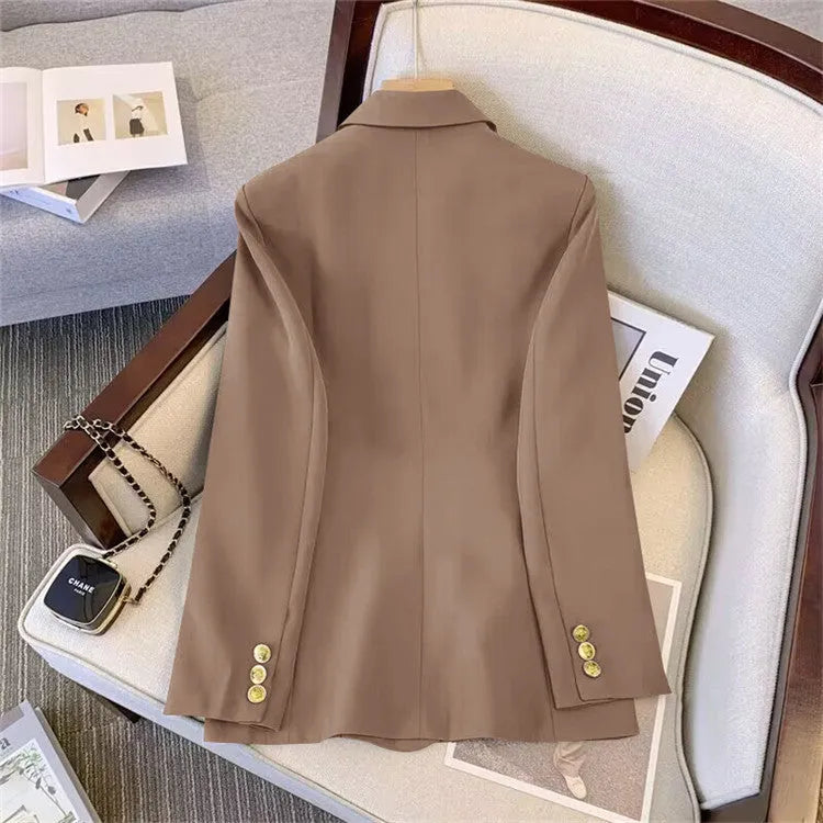 Women's loose black polyester blouse with regular sleeves on a hanger.