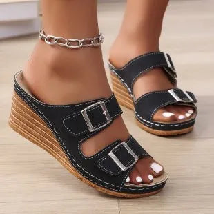 Women's creamy-white beach slippers with an outer wedge belt buckle fastening.