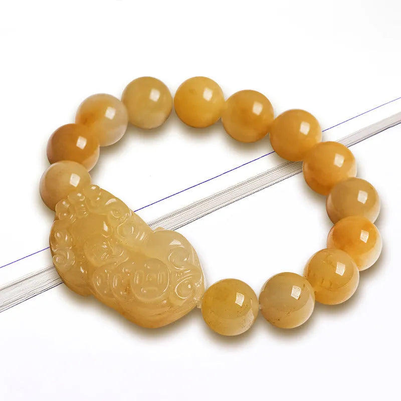 Carved Jinsi Jade money bracelet with Chinese characters on leather cord in gold thread colour