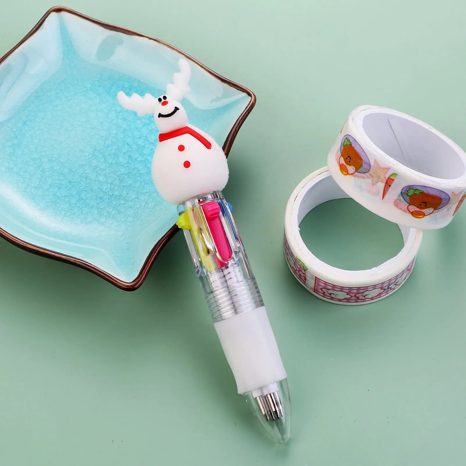 Compact 11cm Christmas-themed press-action ballpoint pen with festive designs.