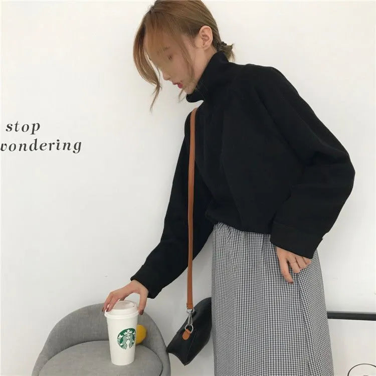 Women's loose-fitting long sleeve top with a half-high collar in a solid colour.