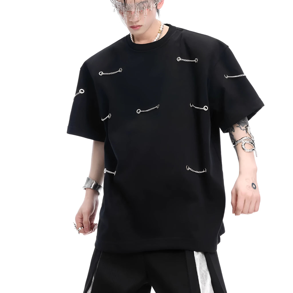 Black cotton blend T-shirt with metal chain detail on padded shoulders, short sleeves, round neck, front view