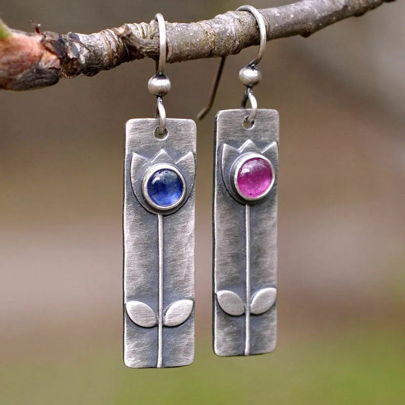 Geometric antique finish earrings with red sapphire detailing and electroplated metal construction