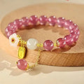 Handcrafted strawberry quartz crystal bracelet with Hetian jade peach blossom charms for women