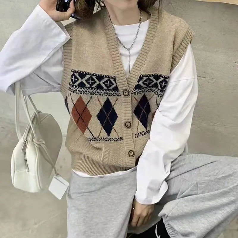 Khaki diamond plaid sleeveless cardigan top laid flat, showing loose fit and sleeveless armholes.