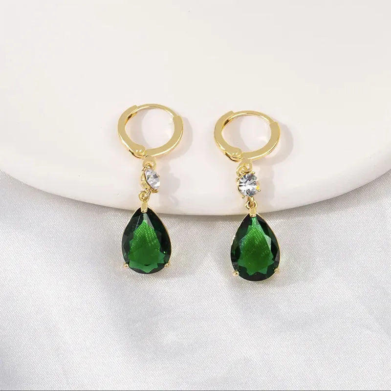Green geometric teardrop alloy earrings on a white background.