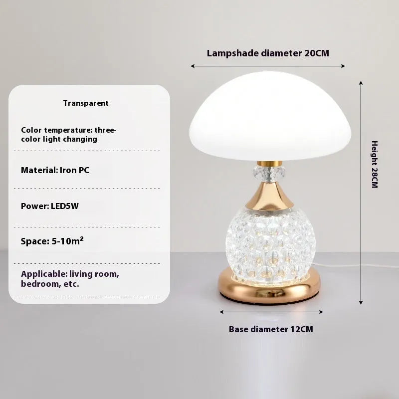 Light luxury mushroom table lamp with carved base in transparent colour on a wooden bedside table