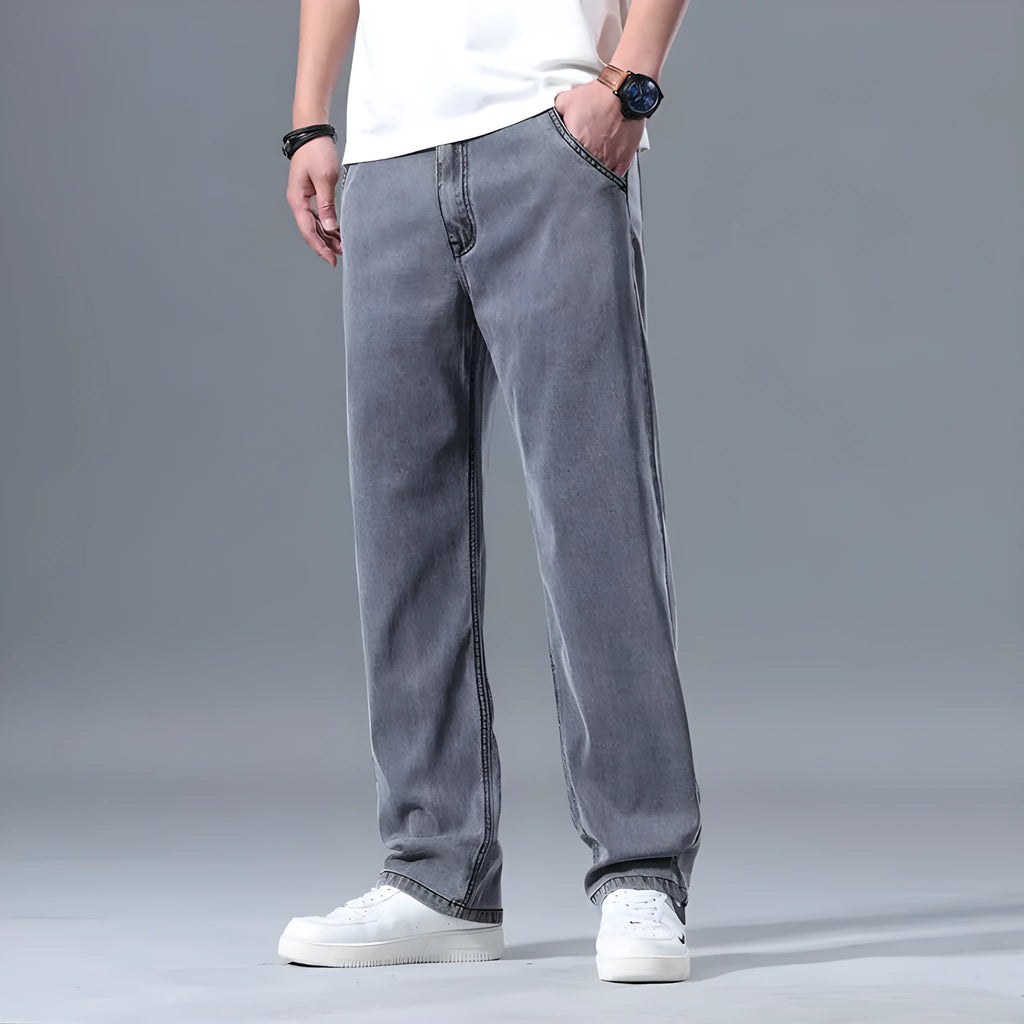 Men's loose straight-leg jeans in a lyocell-blend denim, shown in light blue colour with a zipper fly.