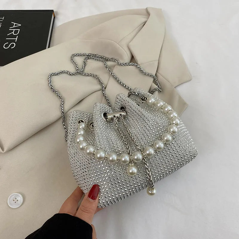 Light diamond pattern shoulder bag with western style chain crossbody and bucket shape design