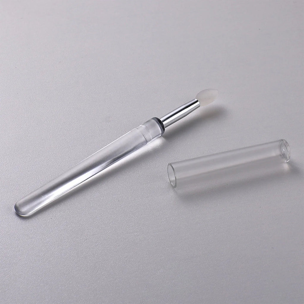 Set of reusable silicone lip brushes with protective caps in various colours.