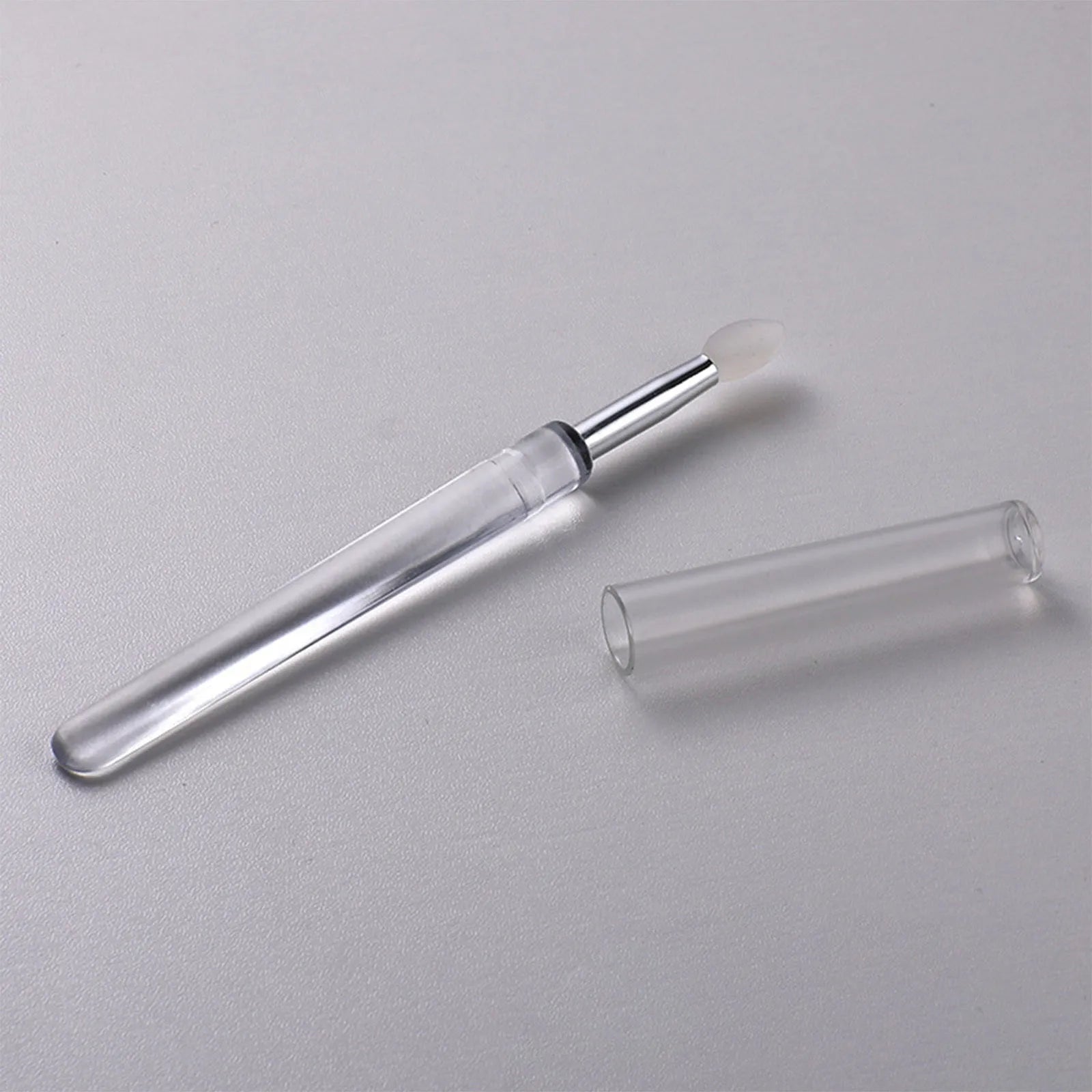 Set of reusable silicone lip brushes with protective caps in various colours.