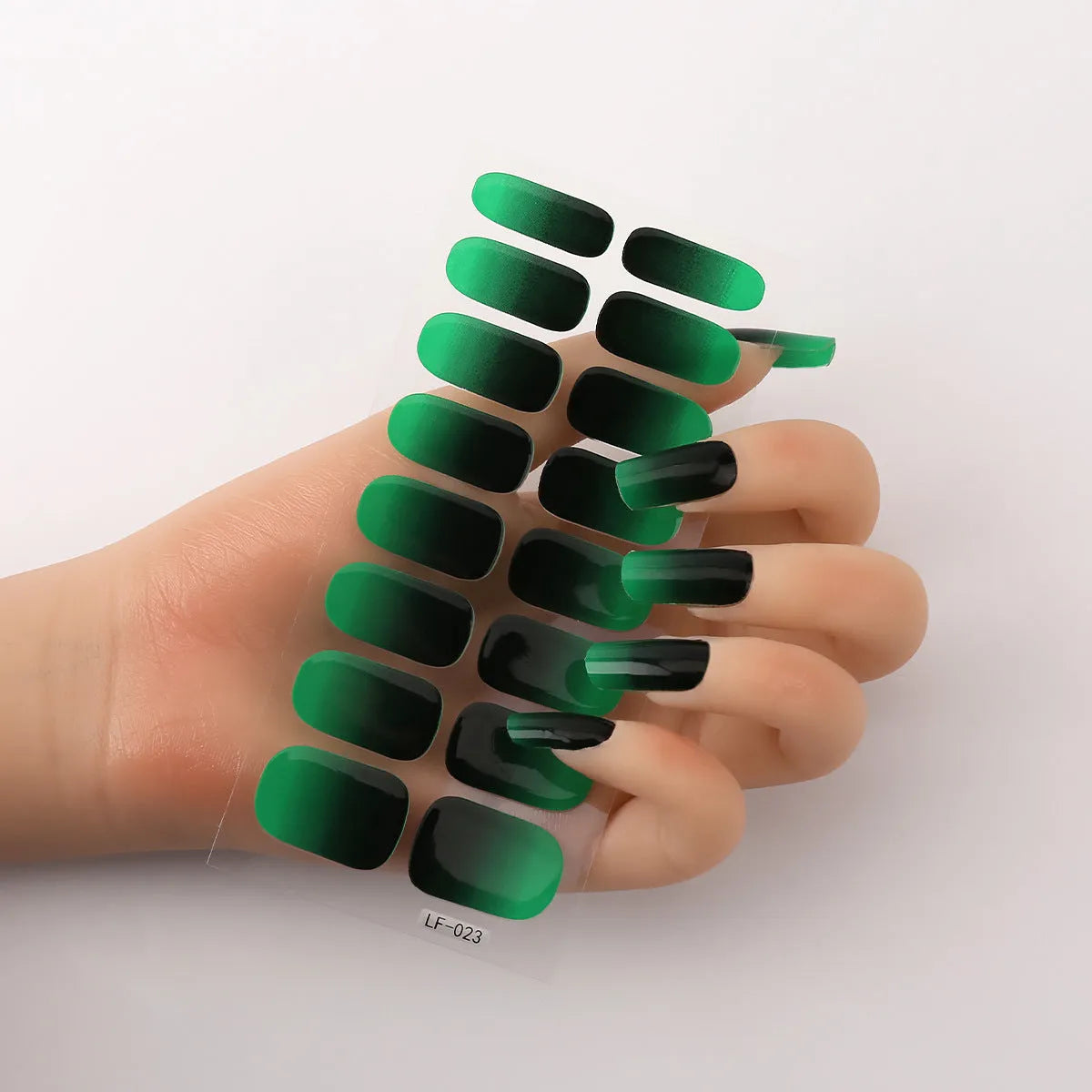 Set of 16 solid colour full nail art stickers showing patterns like cross, rose, tulip, and cartoon designs.