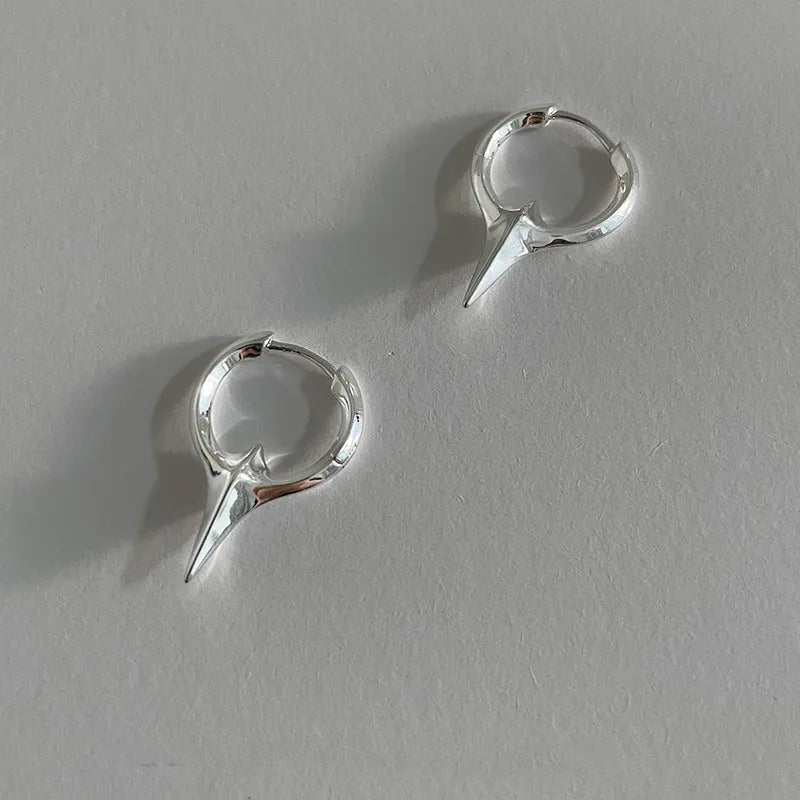 A pair of gold and white electroplated geometric star ear clips made from solid copper for women.