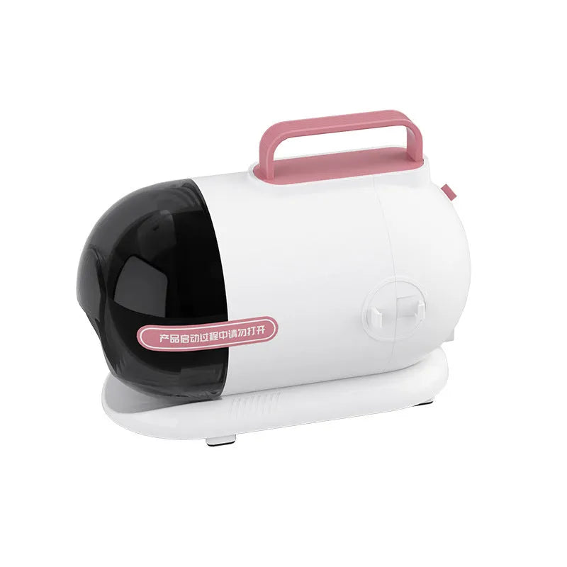 Pink and white pet hair vacuum cleaner with grooming attachments including an electric shear on a flat surface.